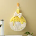 Cute yellow coral fleece doughnut shaped hanging hand towel with a white bow decoration - 20x28cm / Yellow