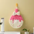 Cute pink donut shaped hanging coral fleece hand towel featuring a white bow tie - 20x28cm / Rose Red
