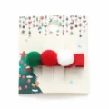 Christmas hair clip with red green white pom-poms on festive display card - Triple Pom-Pom Style