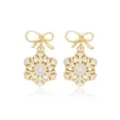 Elegant gold-tone bow snowflake earrings with white enamel finish for Christmas gifts - Gold-Edged Snowflake