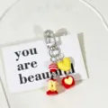 Close-up detail of a cute apple-themed keychain featuring heart and apple core charms - Double Apple Beaded Style