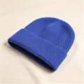 Nahaufnahme einer dicken blauen Strickmütze mit Rippenstruktur für winterliche Wärme - Rippenstrick-Umschlagmütze / Saphirblau