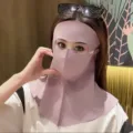 Detail of a pink seamless UV face mask with breathable holes and full neck protection. - One Size / Pink