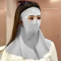 Detail view of a grey seamless UV protection sun mask covering the full face and neck area - One Size / Light Gray
