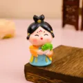 Gros plan détaillé d'une mignonne figurine de dame de la dynastie Tang avec chou. - Style Figurine Dame Tang Richesse