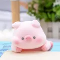 Close-up of a cute pink vinyl pig figurine in a lying position for healing home decor. - Moe Papa Pig (BB3049) / Flocked Texture / Pink