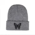 Detailed view showing the black butterfly embroidery on the cuff of a grey knitted beanie - One Size / Butterfly Embroidery Style / Light Heather Grey