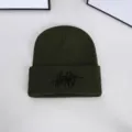 Detailed macro view of a dark green knitted beanie hat with black Heart embroidery - One Size / Embroidered Letter Beanie / Army Green