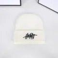 Detailed view of the black HEART embroidery on a white knitted winter beanie hat - One Size / Embroidered Letter Beanie / White