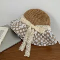 Detailansicht eines Sommer-Strohhuts mit eleganter Blumenspitze und einer Schleife. - Erwachsene 56-58 / Khaki-Netz