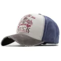 Close-up of a distressed washed cotton baseball cap with skull and truck print - One Size / Coffee Brim