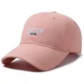 Macro view of pink cotton baseball cap featuring white Boston 1630 embroidery on crown - 55-60cm Head Circumference / Pink