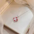 Close-up of elegant red four-leaf clover necklace with sparkling cubic zirconia center - Steel Color (X1601)