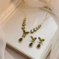 Close-up view of elegant olive green zircon necklace and earrings set in a leaf design - Olive Green Leaf Style (PJ---201)