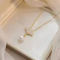 Elegant gold ginkgo leaf necklace with pearl drop and shimmering paved zirconia. - Ginkgo Leaf Artificial Pearl Style (X0734)