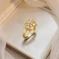 Elegant gold-plated floral ring featuring micro-set sparkling cubic zirconia stones - French Light Luxury Hollow Ring (J1197)