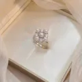 Detailed view of an elegant silver square pearl and zircon cluster ring on satin background - Square Cluster Pearl Ring (J0552)