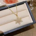 Elegant gold-toned necklace featuring a sparkling zircon-studded snowflake pendant. - X0258 Snowflake Pave Necklace / Gold