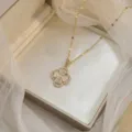 Elegant golden clover pendant necklace with sparkling zircons and cat's eye stones. - X0488--1 (Gold Clover)