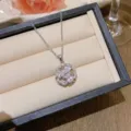 Elegant silver-tone necklace with a zircon-encrusted flower pendant in a jewelry box. - X0259-2 Teardrop Zirconia Four-Petal Flower Necklace / Silver