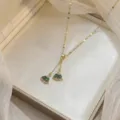Elegant gold necklace featuring two emerald green zircon fan-shaped pendants on fine chain - Fan Shape Petal Square Stone (X0448)