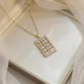 Elegant gold-plated necklace featuring a rectangular pink cubic zirconia pendant. - Light Pink Rectangular Pendant (X0451-2)