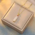 Close-up view of elegant bamboo joint white chalcedony pendant with a gold-tone chain - Red Zirconia White Bamboo (X0020)