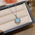 Elegant silver-toned flower pendant necklace featuring a fire opal and clear zircons - X0265 Five-Petal Opal-Look Necklace / Silver