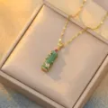 Close-up of green bamboo chalcedony pendant with gold and diamond accents. - Red Zirconia Green Bamboo (X0020)