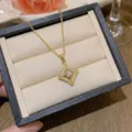 Elegant starburst pendant necklace in gold finish with sparkling cubic zirconia stones - X0271-1 Gold Hollow Star Burst Necklace / Gold
