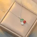 Elegant cherry pendant necklace featuring red, green and white crystal stones on silver chain. - Cherry Style (X0009)