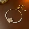 Eleganter vergoldeter Tennisarmband mit rotierendem Zirkonia-Blumenanhänger - Armband (TS0196) / Gold