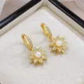 Elegantes pendientes chapados en oro con diseño de flor de perla y piedras de circón. - Pendientes Giratorios Solos (E2004)