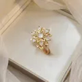 Elegant golden sunburst ring with sparkling zircon stones in a cream jewelry gift box - Purple Sunflower Ring (J0366)