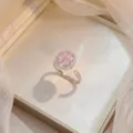 Elegant rotating pink zirconia flower ring with adjustable silver band on cream satin - Bauhinia Rotating Ring (J0238) / Pink