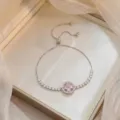 Silver-toned adjustable bracelet with a sparkling pink Bauhinia flower zircon pendant - Bauhinia Rotating Bracelet (TS0262) / Pink