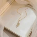 Exquisite gold leaf pendant necklace with shimmering baguette zircons in gift box - Leaf Feather Zirconia (X0677)