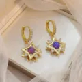 Élégantes boucles d'oreilles étoile dorée avec pierres violettes et zircons brillants - Boucles d'Oreilles Pendantes Starfire (E2038)