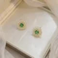 Elegant gold floral stud earrings with green zircon centers in luxury jewelry box - Sun Flower Emerald Earrings (E0472)
