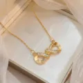 Elegant gold-tone infinity symbol necklace featuring shimmering cubic zirconia stone accents - Gold Infinity Zirconia (X0689-1)