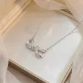 Elegant silver-toned infinity bow necklace featuring sparkling cubic zirconia stones - Silver Infinity Zirconia (X0689-2)