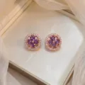 Exquisite rose gold stud earrings with purple flower design and sparkling zirconia. - Bauhinia Rotating Earrings (E0007) / Rose Gold and Purple