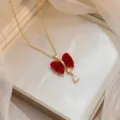 Elegant gold necklace featuring a red velvet bow and teardrop zircon pendant in box - Red Velvet Bowknot Drop (X0698)