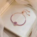 Rose gold rotating flower bracelet with purple zircons on velvet box. - Bauhinia Rotating Bracelet (TS0018) / Rose Gold and Purple