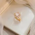 Elegant gold adjustable ring with a rectangular clear stone and pink halo crystal detail - Rectangular Clear Rhinestone Ring (J0246)