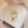 Elegant gold-plated flower ring with micro-pave white zircon stones in a jewelry box - Layered Micro-inlaid Zirconia Flower Ring (J1209)
