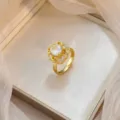 Elegant 18k gold-plated flower ring featuring micro-pave cubic zirconia accents - Hollow Flower Solitaire Ring (J1211)
