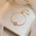 Adjustable gold finish bracelet with pink rotating flower design and CZ inlay - Heart Rotating Bracelet (TS0211) / Gold Pink