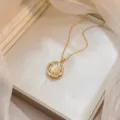 Elegant golden rotating Bauhinia flower necklace with opal and sparkling zircon detail - Cat's Eye Stone Rotating Necklace (X0764) / Gold