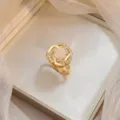 Elegant gold rotating bauhinia flower ring featuring a cat eye stone and micro-pave zircons - Cat's Eye Stone Rotating Ring (J0367) / Gold
